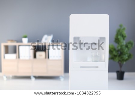 Modern water cooler in office Royalty-Free Stock Photo #1034322955