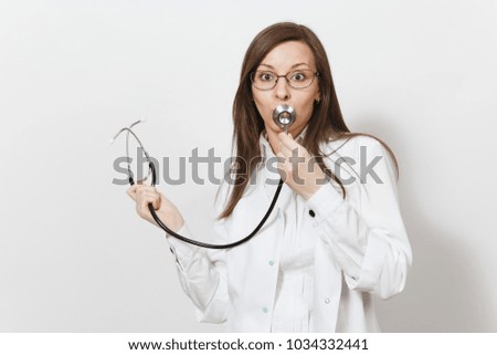 Smiling pretty fun experienced beautiful young doctor woman holding stethoscope isolated on white background. Female doctor in medical gown glasses. Healthcare personnel, health, medicine concept
