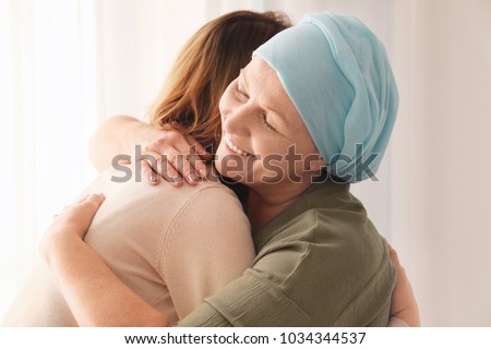 Woman hugging her mother with cancer indoors Royalty-Free Stock Photo #1034344537