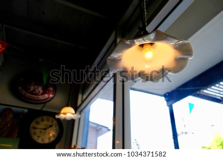 Blurred picture of vintage lanterns hanging in coffee shop with space for your text and design. Concept be used for interior decoration of coffee shop and restaurant.