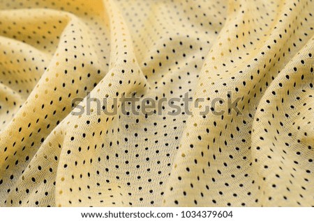 Yellow sport jersey clothing fabric texture and background with many folds