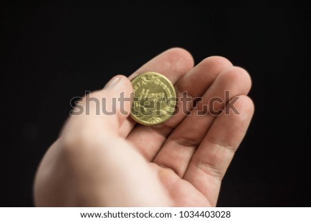 Hand throws a coin. The concept of decision-making.