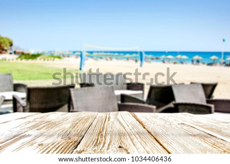 Table background of free space and blurred background of beach 