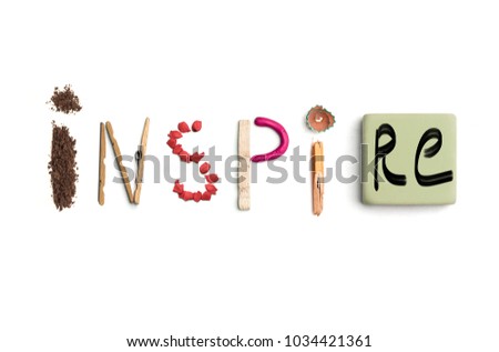 Concept of idea with colorful crumpled paper. The word inspire created from office stationery. The art, creative, letters concepts. Conceptual image. Top view, isolated on white desk. Work tool