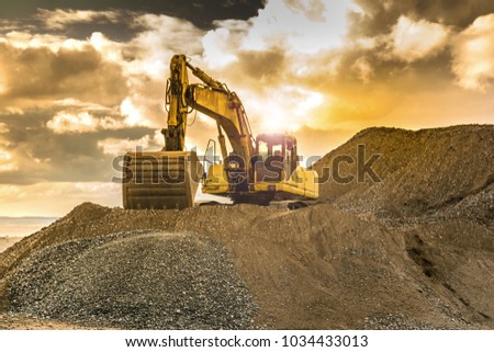 Large excavator worked on a site Royalty-Free Stock Photo #1034433013