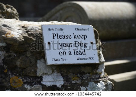 Close up on a sign in church yard about handling dogs