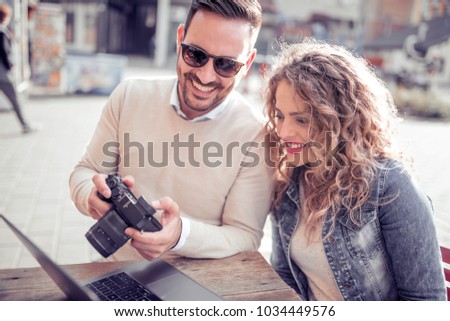 Young couple taking photo picture in the city.Autumn,holidays and dating concept.