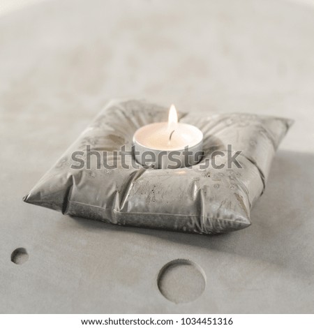 Modern concrete candlestick on concrete gray background