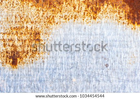 Texture of vintage rusty gray iron wall background with many layers of paint and rust