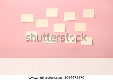 Empty yellow stickers on wall. Office  table 