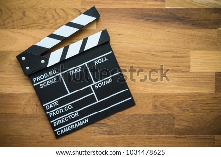Cinema clapperboard on wooden background - Movie entertainment concept
