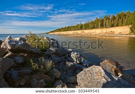 View through rocks on coastline of beach of sea, Russia.