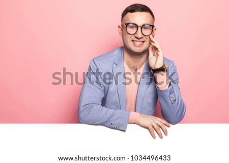 Handsome man in bright jacket with white banner