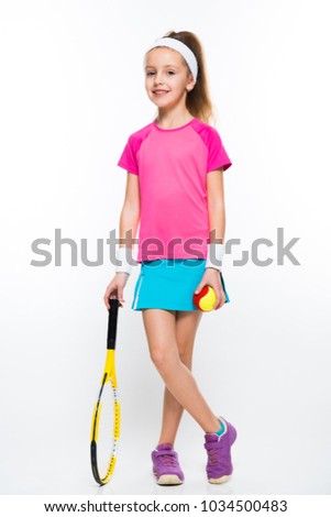 Cute little girl with tennis racket and ball in her hands on white background