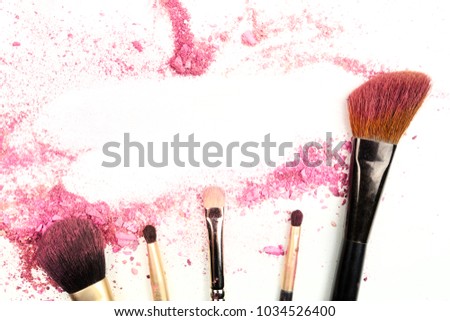 Traces of vibrant pink powder and blush forming a frame, with makeup brushes. A template for a makeup artist's business card or flyer design, with a place for text