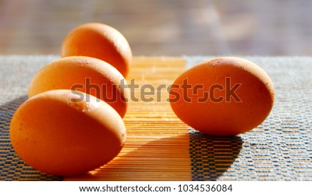 selective focus picture of some fresh eggs on bamboo weave pattern, close up soft focus background  