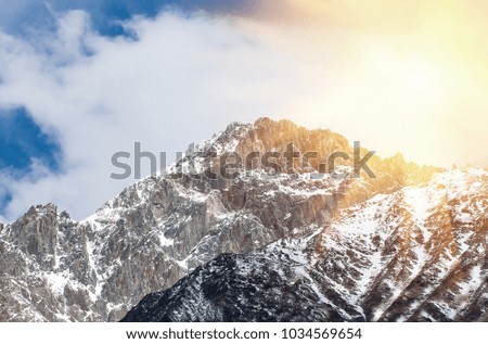 Mountain landscape with snow-capped  mountain range in warm sunlight
