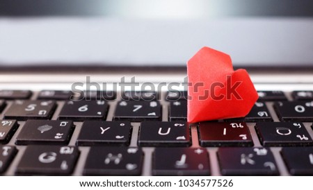 I love you and valentine concept, red heart origami paper is between I and U alphabets black computer keyboard, containing thai alphabets on board