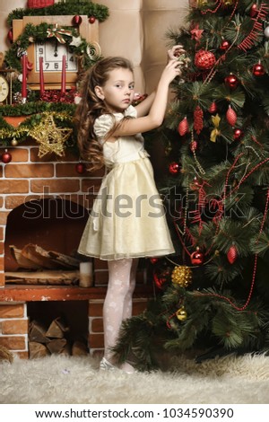 Girl decorates the Christmas tree