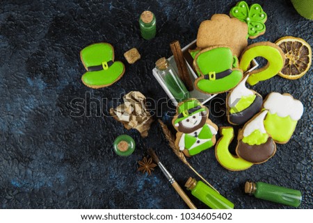 Gingerbreads cookies for Patrick's day on black concrete background
