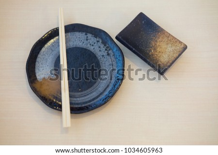 Top view of chopsticks with empty dish. Japanese sushi chopsticks and soy sauce bowl