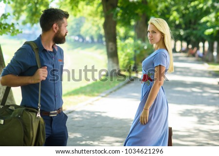 Love at first sight concept. Man and woman likes each other. Casual encounter, meet on sunny summer day, nature background, defocused. Man with beard and blonde girl stopped to get acquainted. Royalty-Free Stock Photo #1034621296