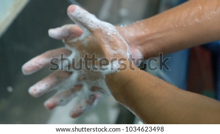 Scrubbing and gloving for surgeons in operation theatre.  Royalty-Free Stock Photo #1034623498