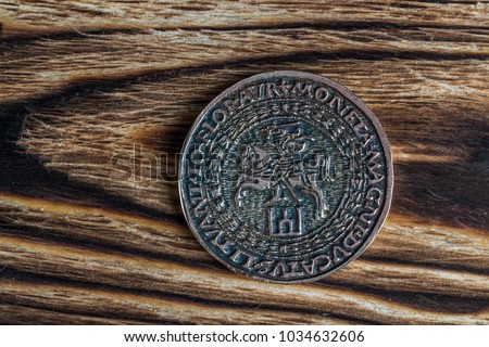 Old coin on wooden background