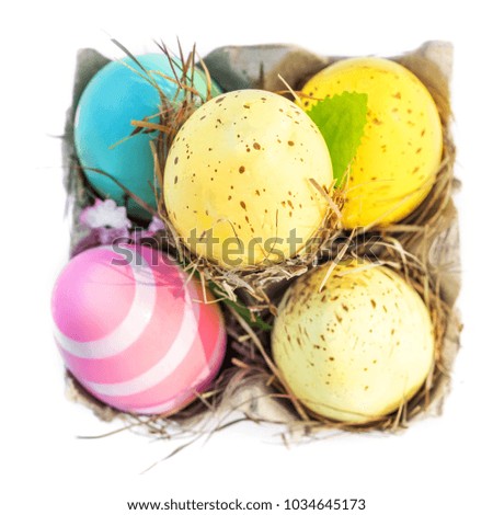 Decoration Easter Eggs with copy space.  Easter eggs in egg cartoon box on white rustic wooden background
