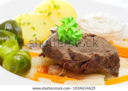 tafelspitz meat on a plate with vegetables 