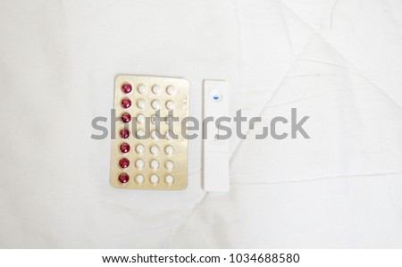 Birth control pills Pregnancy test on a white background.