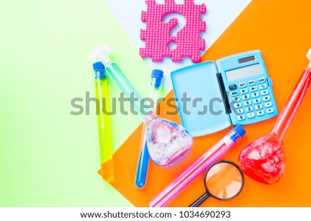 Chemistry class makes chemistry experiment. STEM. Robotics, mechanic, chemistry, biology. Modern education. Fun and interesting. Colorful paper background Top view