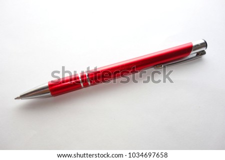 Red ballpen isolated on white background Royalty-Free Stock Photo #1034697658