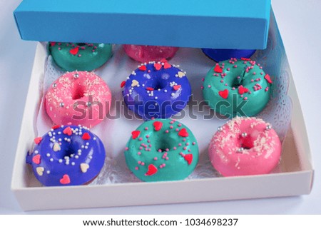 Delicious, multi-colored donuts in a gift box