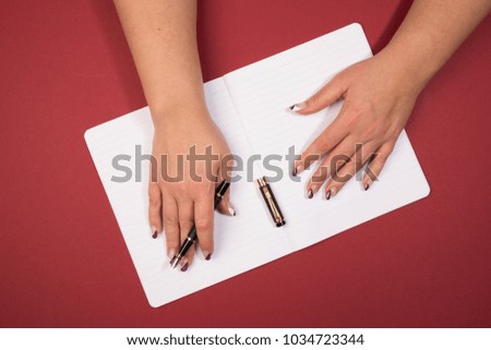 holding a ink pen in open hand