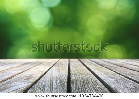 Wood Picnic Table Texture Over Green Spring Nature Blurred Background