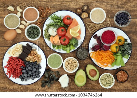 Health food concept to boost brain power and promote memory with fish, fruit, vegetables, nuts, seeds, herbs, supplement powders and tablets on rustic wood background. Top view. Royalty-Free Stock Photo #1034746264