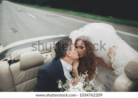 Happy bride and groom posing after wedding ceremony