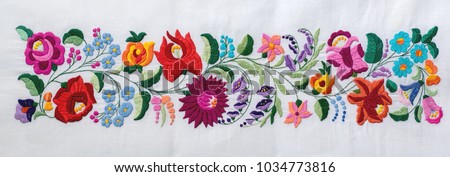 Traditional Hungarian embroidery is made on the foot sewing machine Royalty-Free Stock Photo #1034773816