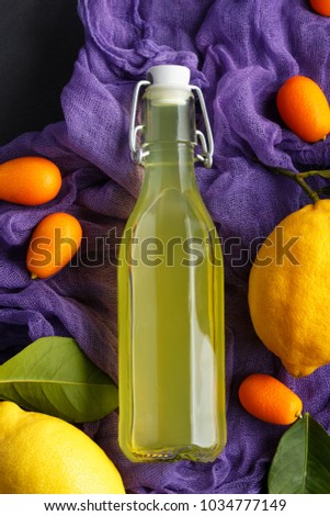 lemonade on a dark background. summer traditional Italian home-made drink from Sicilian lemons. products from fruit in a low key. old background with a picture of a drink in a bottle 
