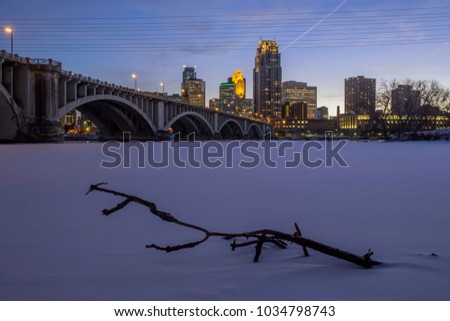 Twilight Shot of Minneapolis Above the Third Avenue Bridge and Fresh Snow on the Frozen Mississippi River