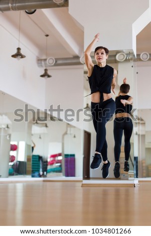 woman jumping in the gym, doing exercises