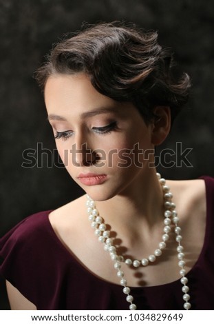 beautiful brunette girl with beads in retro style close-up