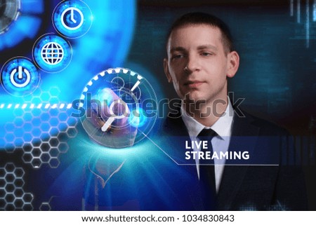 Business, Technology, Internet and network concept. Young businessman working on a virtual screen of the future and sees the inscription: Live streaming