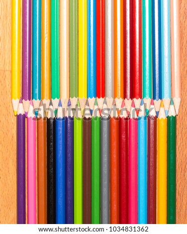 Color pencils isolated on the wooden background
