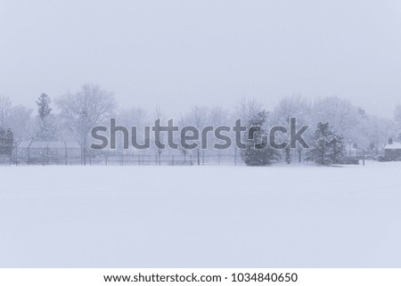 Suburban school field in a park under a heavy winter snow