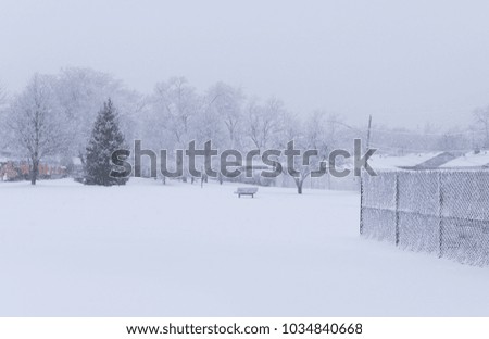 Suburban school field in a park under a heavy winter snow