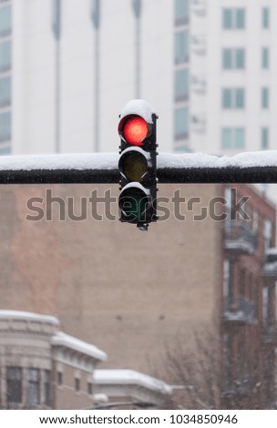 Traffic light outside under a heavy snow