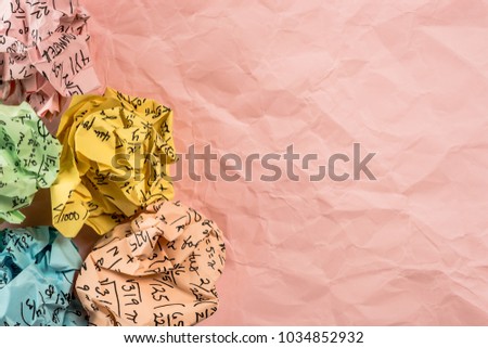 A group of multi colored crumpled paper with mathematical equations. A bunch of multi colored torn paper with mathematical equations on it, background. Crumpled multi colored paper ball.