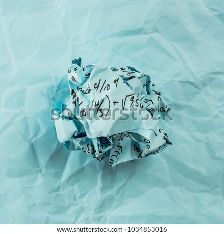 A group of multi colored crumpled paper with mathematical equations. A bunch of multi colored torn paper with mathematical equations on it, background. Crumpled multi colored paper ball.